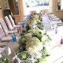 All white table centre of white hydrangeas, white roses and baby’s breath at Goodwood.